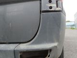 a close up of a car ' s rear bumper with a hole in it