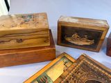 three wooden boxes with paintings on them sitting on a table