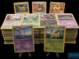 a lot of pokemon cards sitting on top of each other