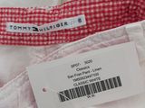 the label on a white shirt has a red and white checkered pattern