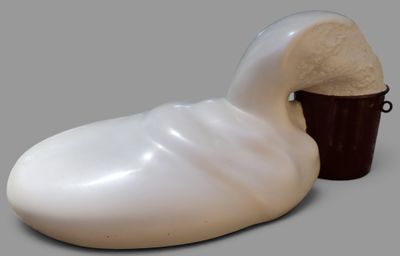 a white duck shaped object with a bucket of ice cream