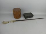a small wooden box, a brush, and a box on a white surface