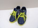 pair of blue and yellow tennis shoes with yellow laces on a white surface