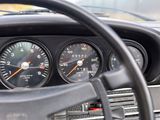 a close up of a dashboard with gauges and a steering wheel
