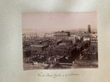 a black and white photo of a city with a clock tower