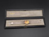 an image of a watch in a box on a black surface