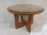 an image of a wooden table with a glass top on a tile floor