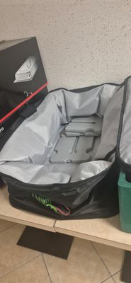 two pieces of luggage sitting on a shelf next to each other
