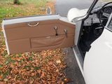 a white car with its door open on the side of the road