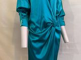 un mannequin portant une robe vert sarcelle nouée à la taille