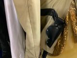 several jackets and jackets hanging on a rack in a store