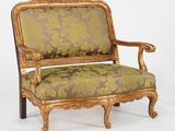 un fauteuil rembourré doré et vert sur fond blanc
