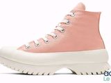 a close up of a pair of pink sneakers on a white background