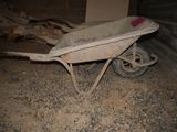 a dirty wheelbarrow in the middle of a dirty room