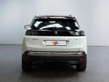 the rear end of a white suv parked in a room