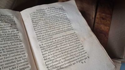 an open book sitting on top of a wooden table