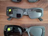 trois paires de lunettes de soleil noires posées sur une surface en bois