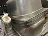 a metal sink with a metal pan on top of it