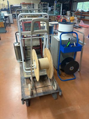 a cart with a reel and a cart with a hose on it