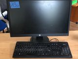 a desktop computer sitting on a desk with a keyboard and mouse