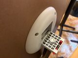 a remote control on the side of a table