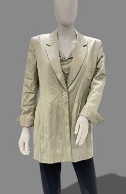 a mannequin dressed in a gold jacket and black pants