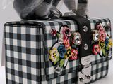 a black and white checkered purse with flowers on it