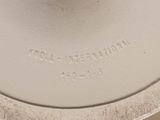 a close up of a white vase on a table