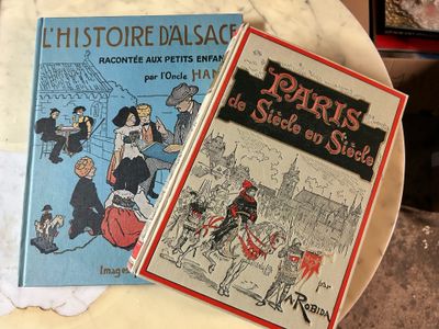 two books sitting on a plate on a table