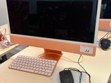 a computer monitor sitting on a desk with a keyboard and mouse