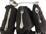 a spoon, fork, and napkin on a table