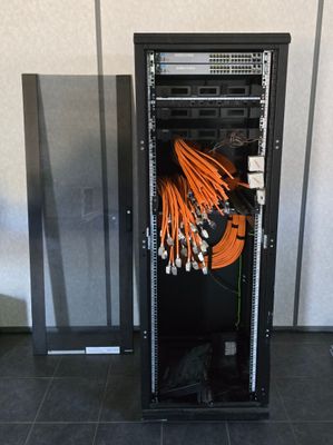 a rack with a bunch of cables in it in a room