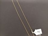 a gold necklace with a tag on it and a chain attached to it
