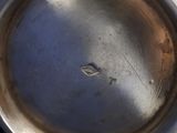 a silver plate with a hole in the middle of it