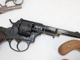 a gun that is sitting on a table next to a pair of scissors
