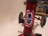a close up of a red bicycle with a sticker on it