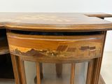 a wooden table with a glass door on it