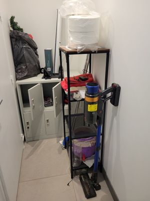 an image of a small room with a shelf and a mop