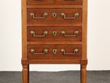 a wooden chest of drawers with brass handles and a marble top