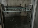 an open oven with a rack in the middle of it