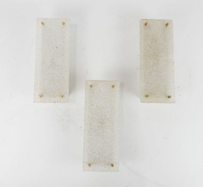 three white marble blocks sitting on top of a white surface