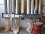 many rolls of paper sitting on a shelf next to a red barrel
