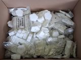 a cardboard box filled with lots of white items