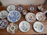many plates and bowls sitting on a wooden table