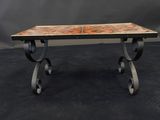 a table with a marble top and iron legs