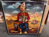 an old picture of a clown playing an accordion with a dog