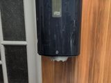 a toilet and a paper towel dispenser in a bathroom