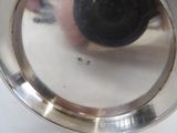 a silver plate with a black object in it