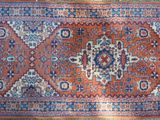 a close up of a rug on a wooden floor