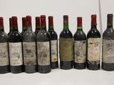 several bottles of wine are lined up in a row